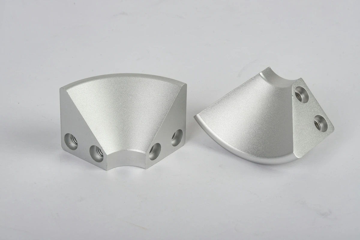 Machined aluminum corner components with mounting holes