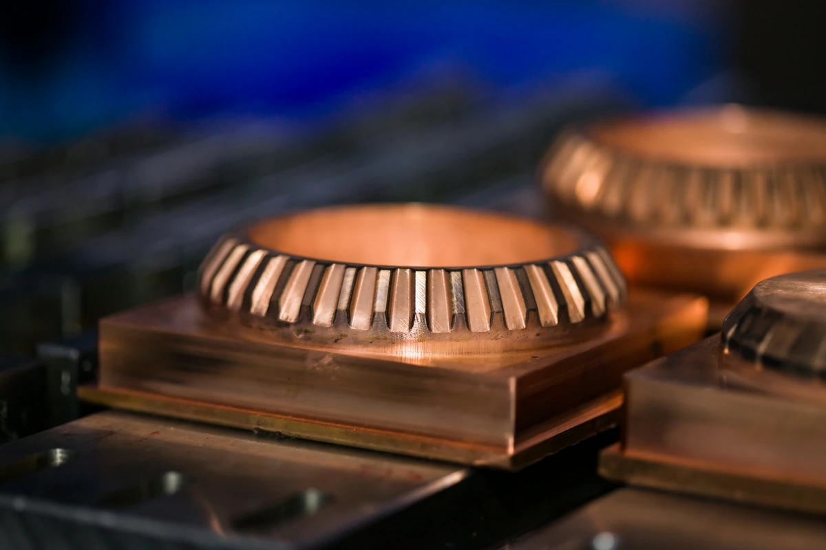 Machined copper components secured on a production fixture