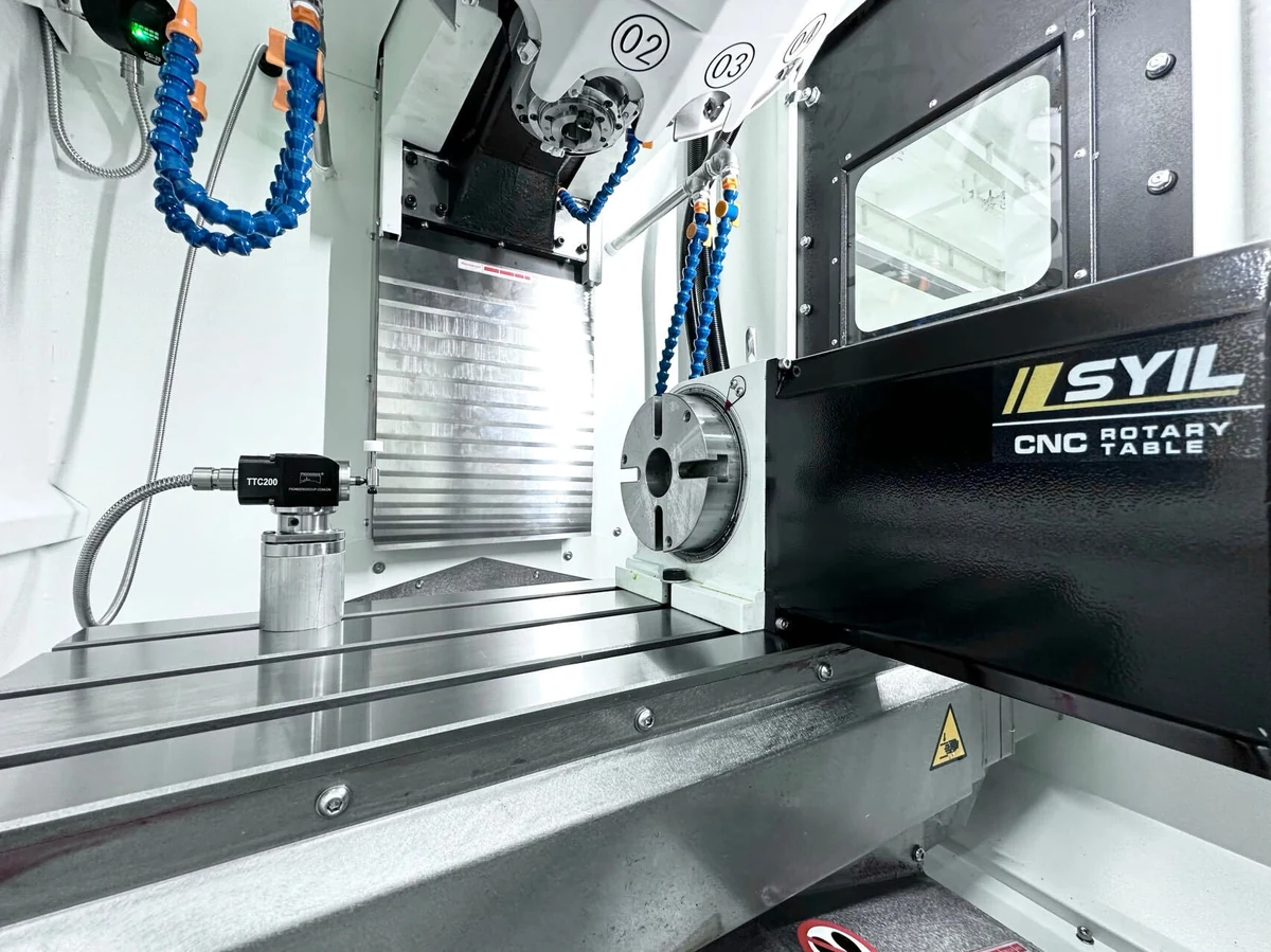 CNC machining center interior with rotary table and tool setter