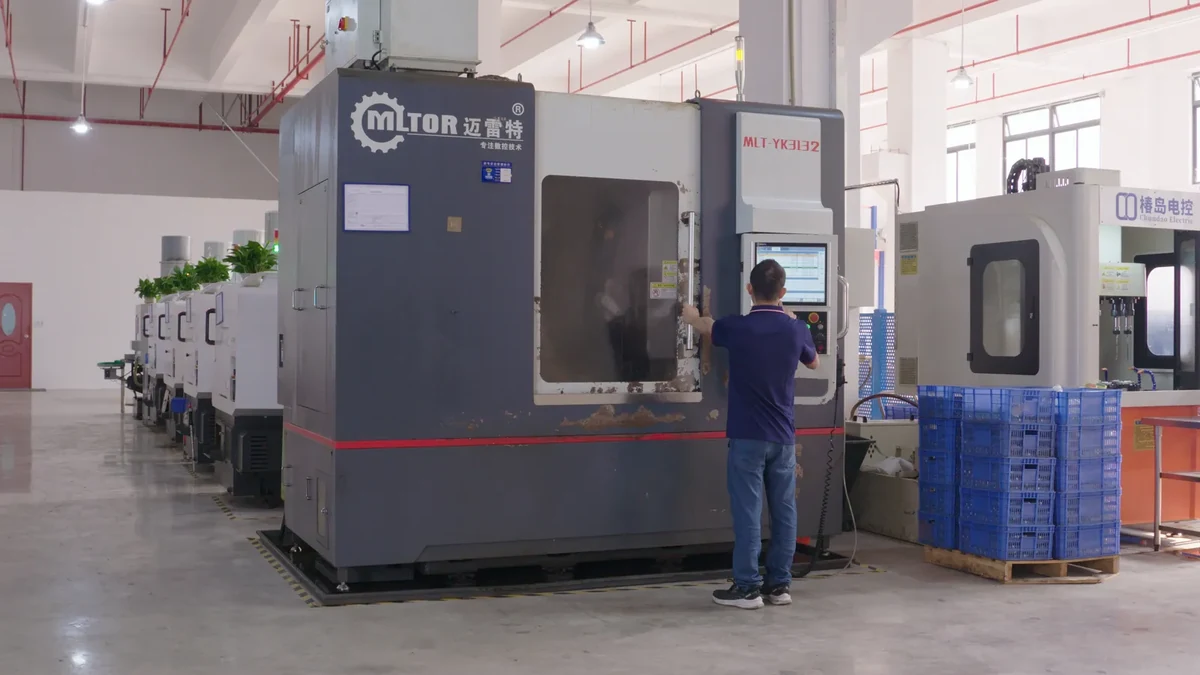 Operator beside an enclosed vertical machining center